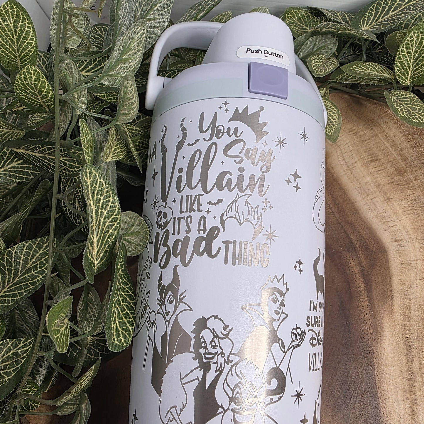 A white thermos with a silver design featuring characters from the Disney film "The Little Mermaid".