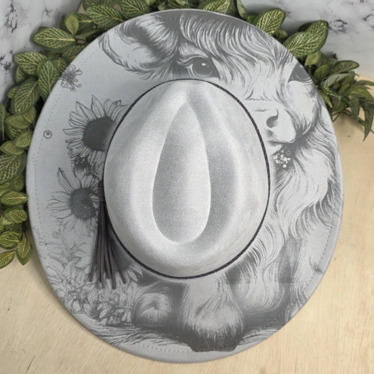 Country western laser engraved hat flat lay on wood background