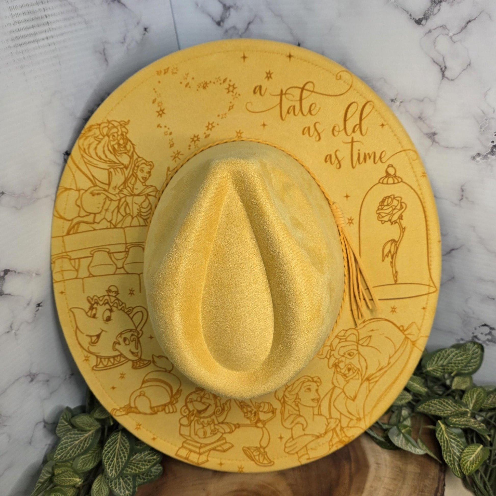 Beauty and the Beast inspired engraved fedora hat flat lay