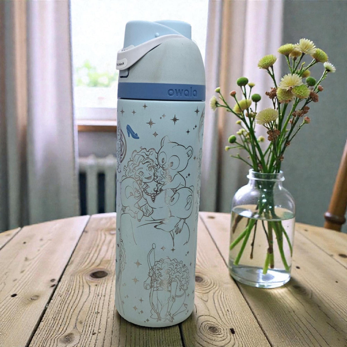 Engraved Owala tumbler with Princess Merida design on wooden table