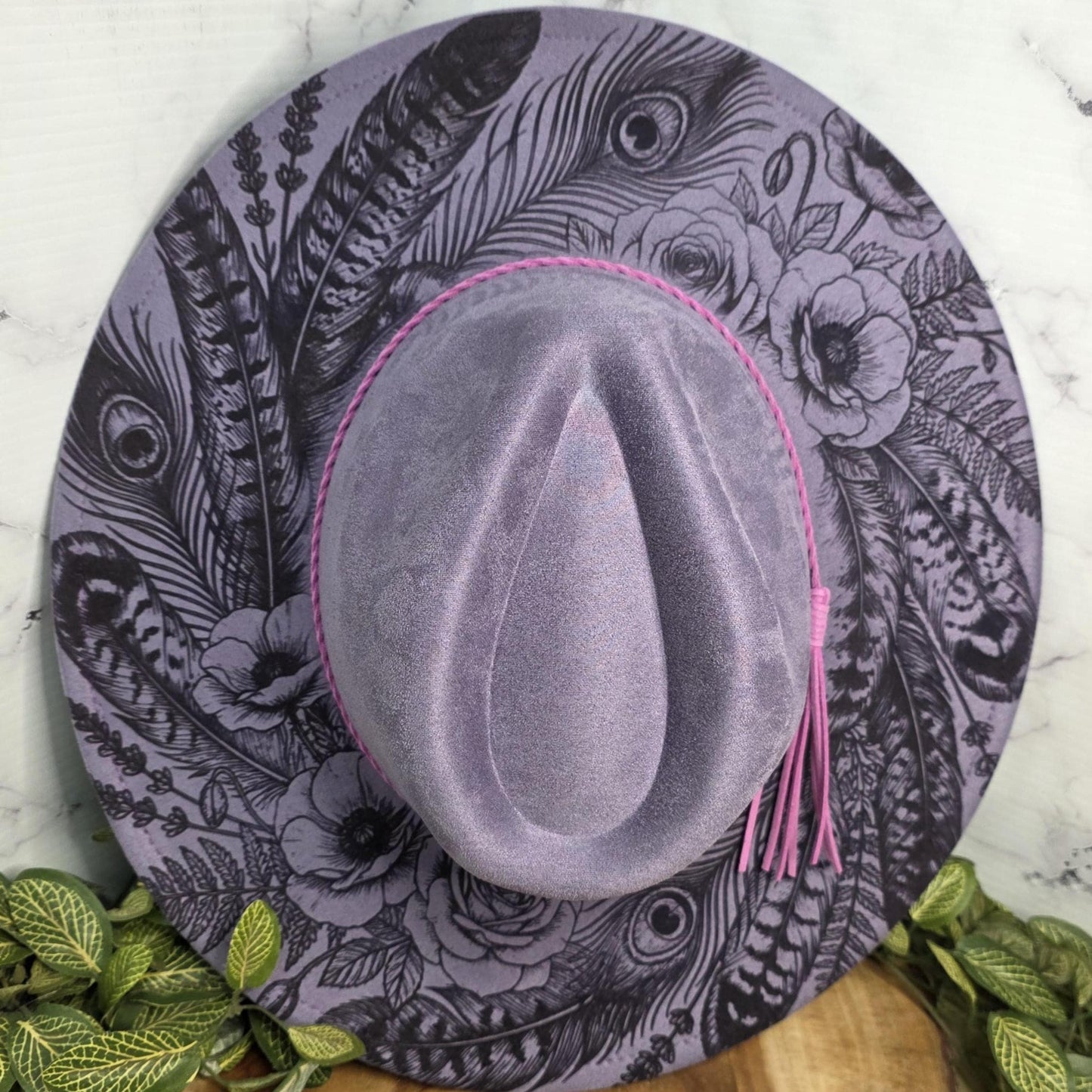 Laser engraved feather design on lavender vegan suede wide brim hat with pink braided band and tassel accent