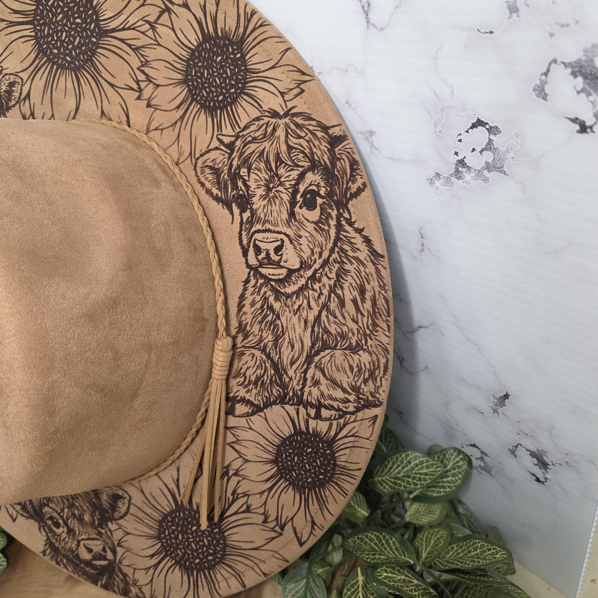 Laser engraved vegan suede hat with sunflowers and highland cows design